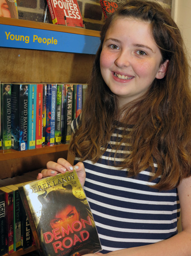 Milly Gibbons smiling with library books