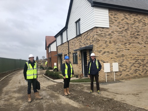 Three staff members on site checking new homes