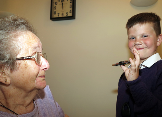 photo of resident with schoolboy and fidget spinner