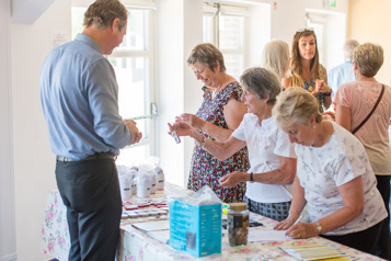 Financial Wellbeing Manager Mark Faithful giving advice to three women