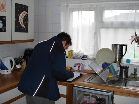 Engineer doing checks in a kitchen