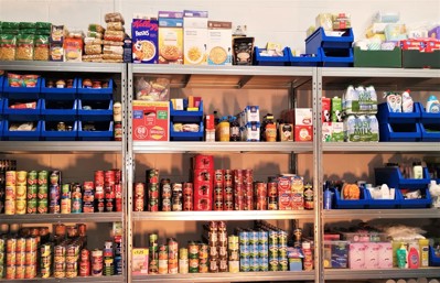 foodbank shelves stacked with lots of food