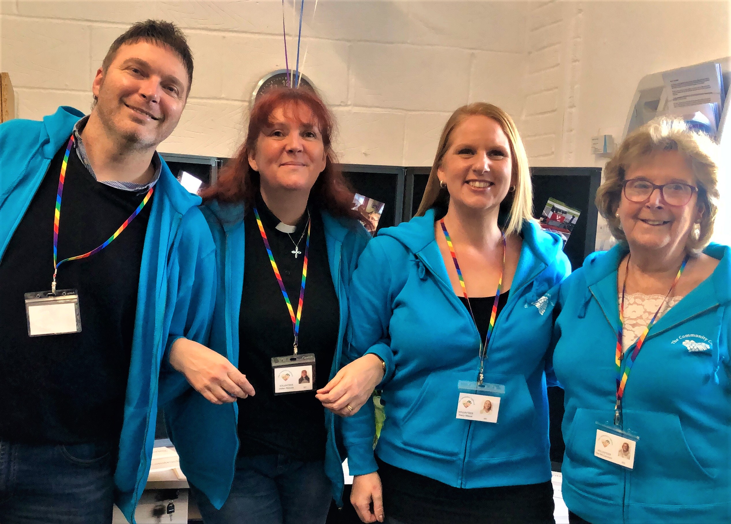 trustees of the foodbank smiling and linking arms