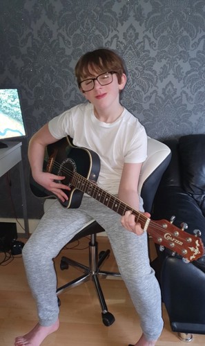 Albie playing his guitar