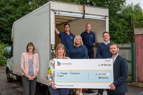 Brenwards, West Kent and Abacus staff stand next to the van with a large cheque